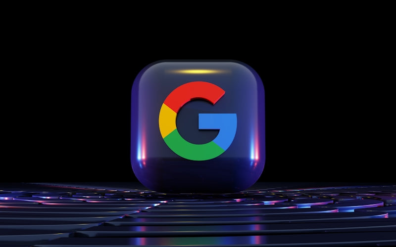 a close up of a computer keyboard with a google logo on it