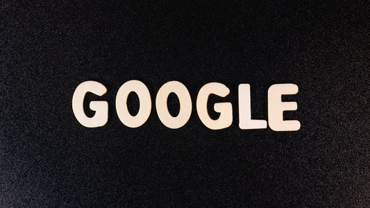 a close up of the word google on a black surface
