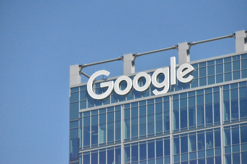 A tall building with the google logo on top of it